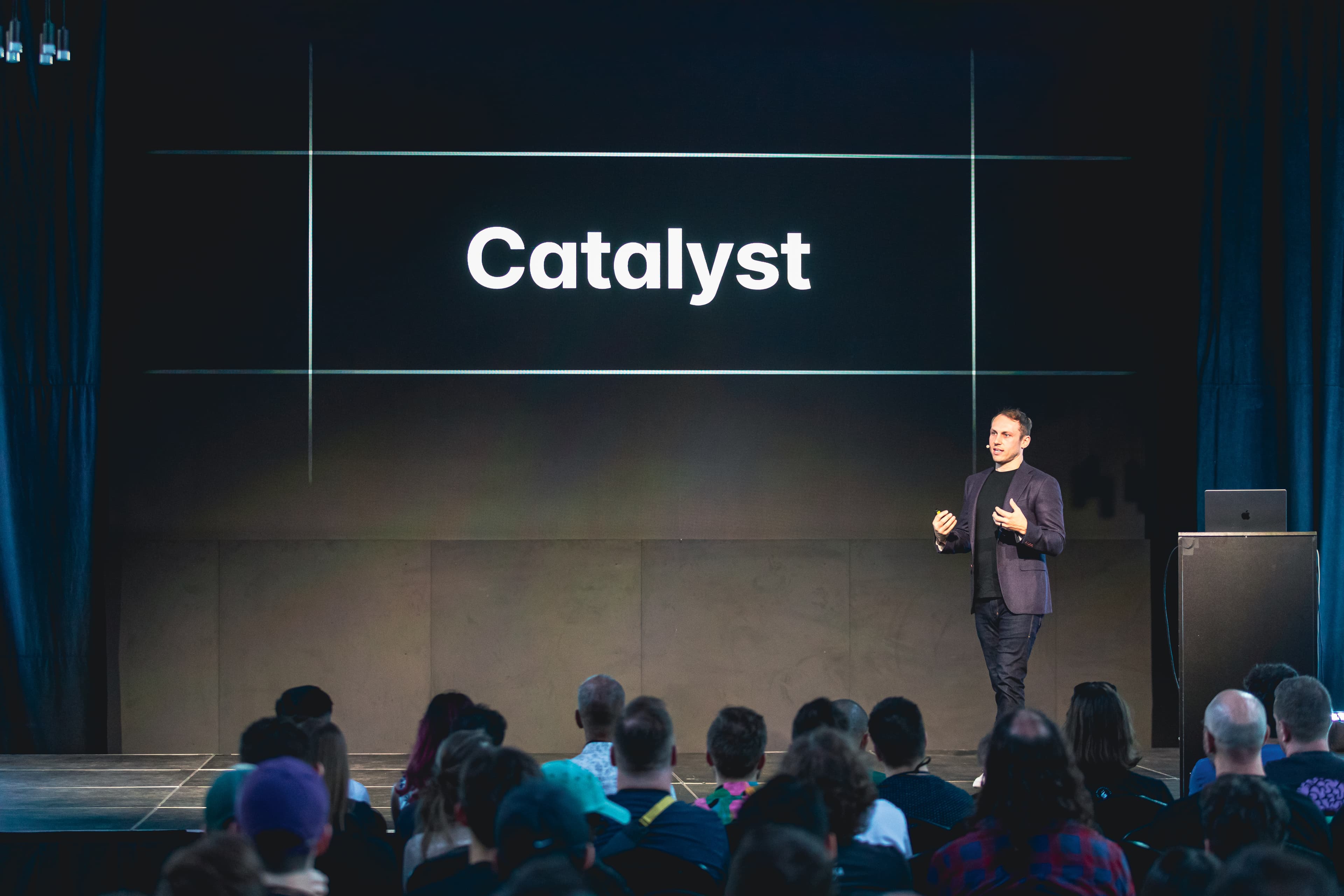 Adam Wathan on stage in front of a slide that says Catalyst